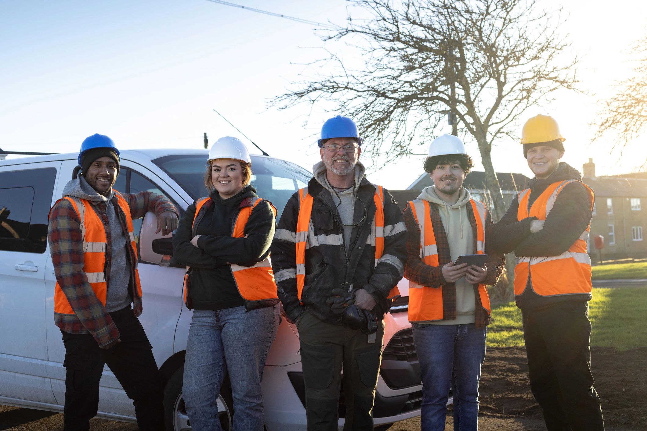 Professional facility support team standing together at an outdoor worksite