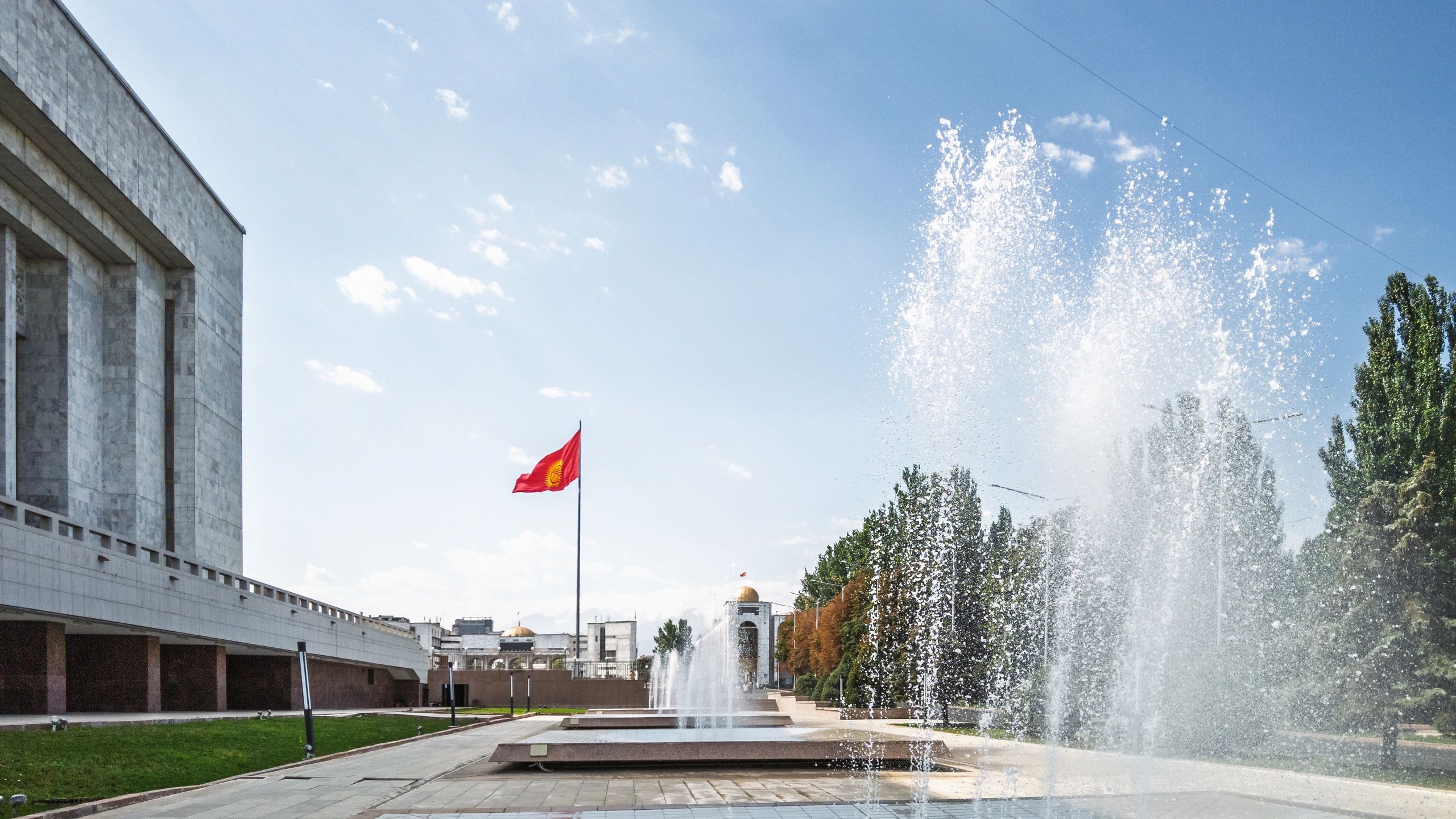 Clean civic plaza with modern public building and landscaped surroundings